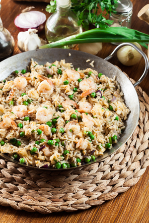 Fried rice with shrimp and vegetables on a frying pan. Popular chinese dishの写真素材