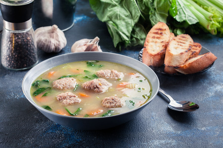Italian wedding soup with meatballs,  pasta orzo and vegetables. Served in plateの写真素材