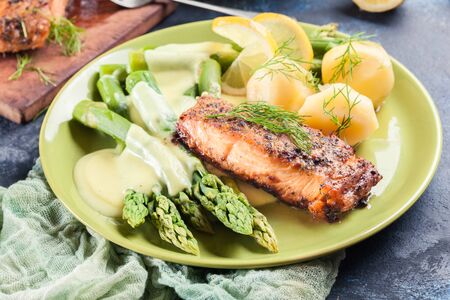 Baked salmon with asparagus and hollandaise sauce.Spring dishの写真素材