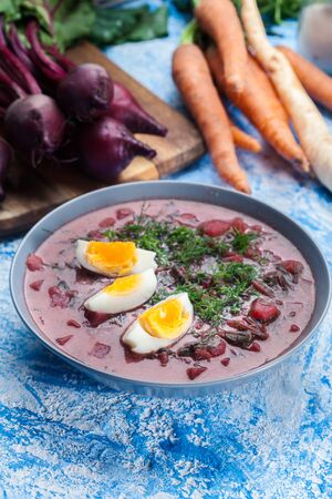 Beetroot soup served with boiled egg garnished with fresh dillの写真素材