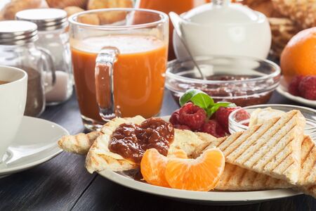 Fresh and continental breakfast table with jam on toast