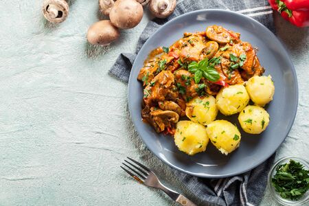 Fresh turkey ragout with mushrooms in creamy sauce with boiled potatoesの写真素材