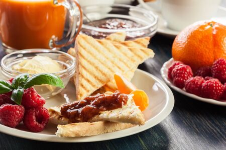 Fresh and continental breakfast table with jam on toastの写真素材