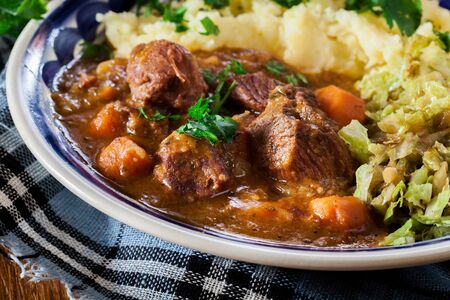 Traditional irish stew served with mashed potatoes and cabbageの写真素材
