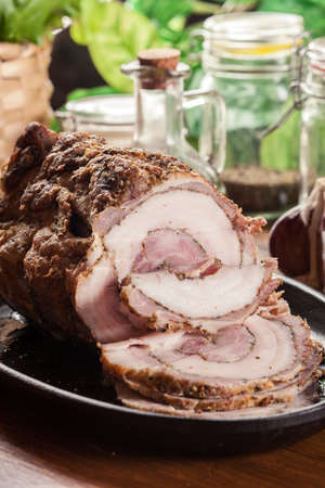 Baked pork belly roulade. Sliced bacon rollsの写真素材
