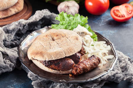 Cevapcici or cevapi served with lepinja bread and onion. Popular dish all over the Balkansの写真素材