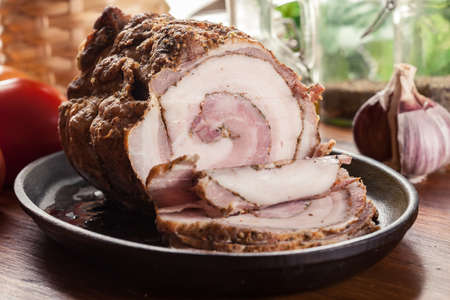 Baked pork belly roulade. Sliced bacon rollsの写真素材