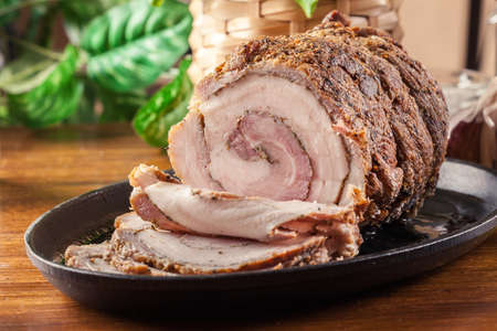 Baked pork belly roulade. Sliced bacon rollsの写真素材