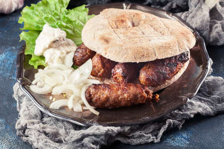 Cevapcici or cevapi served with lepinja bread and onion. Popular dish all over the Balkansの写真素材