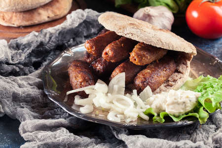 Cevapcici or cevapi served with lepinja bread and onion. Popular dish all over the Balkansの写真素材