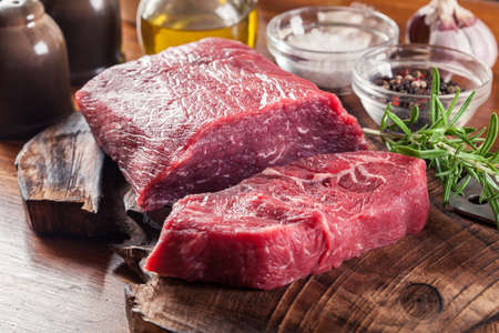 Raw beef steak on a cutting board. Making steak for grillingの写真素材