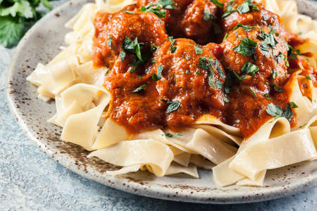Meatballs with tomato sauce served with pappardelle pasta. Italian cuisineの写真素材