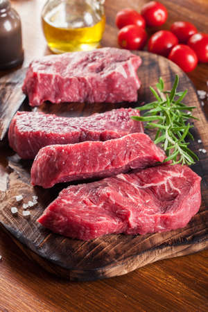 Raw beef steak on a cutting board. Making steak for grillingの写真素材