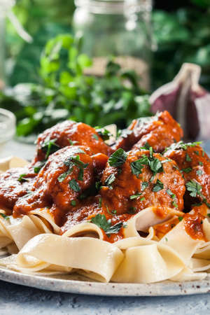 Meatballs with tomato sauce served with pappardelle pasta. Italian cuisineの写真素材