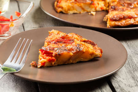 Tortilla de Patatas. Spanish omelette with sausage chorizo, potatoes, paprika and egg, accompanied by olive oil. Spanish cuisineの写真素材