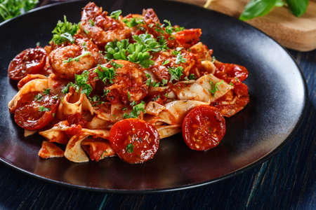 Pappardelle pasta with shrimp, tomatoes and herbs. Italian cuisineの写真素材