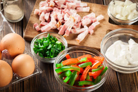 Ingredients for preparing omelette with bacon and vegetables. Breakfast time.の写真素材