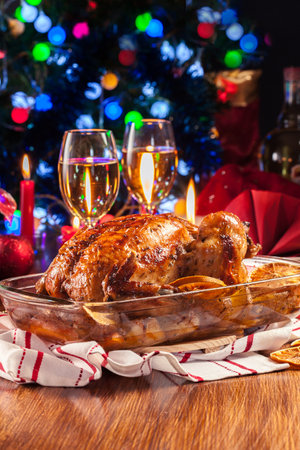 Baked or roasted whole chicken on Christmas table. Xmas dinnerの写真素材