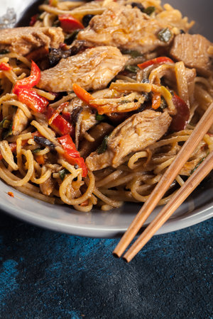 Chicken chow mein. Popular fried noodles with chicken and vegetablesの写真素材