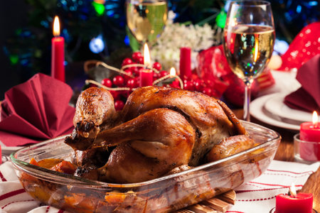 Baked or roasted whole chicken on Christmas table. Xmas dinnerの写真素材