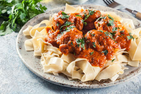 Meatballs with tomato sauce served with pappardelle pasta. Italian cuisineの写真素材