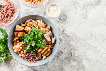 Buddha bowl lunch with chicken and red rice, chickpea, cauliflower and Halloumi cheese. Healthy food conceptの写真素材