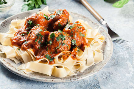 Meatballs with tomato sauce served with pappardelle pasta. Italian cuisineの写真素材