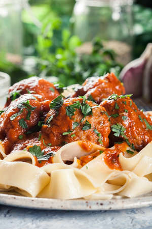 Meatballs with tomato sauce served with pappardelle pasta. Italian cuisineの写真素材