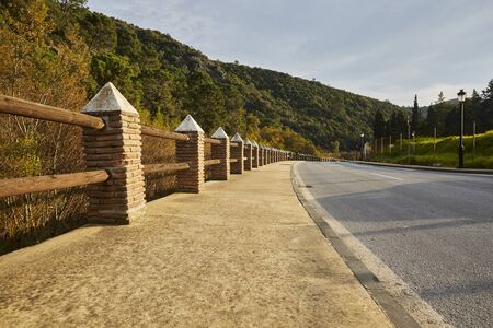 beautiful mountain road with a curve to the right going up the mountainの写真素材