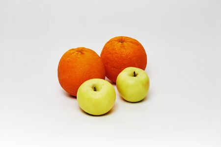 nice and simple still life of two oranges and two apples on white backgroundの写真素材