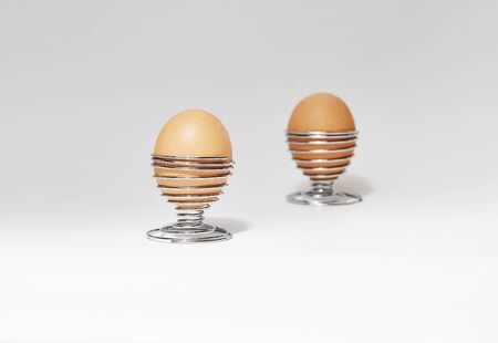still life of chicken eggs on white background in iron bowlの写真素材