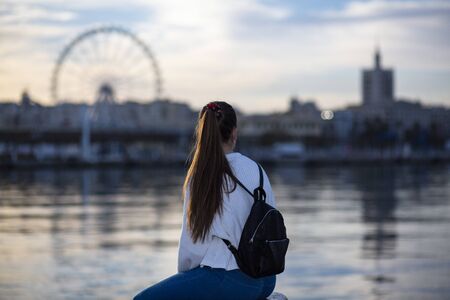 beautiful woman looking at the sea in the port of malagaの写真素材
