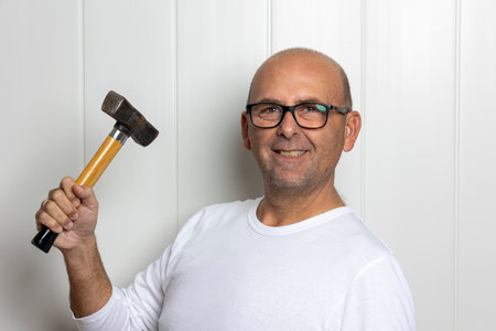 photographs of a man over 50 with construction toolsの写真素材