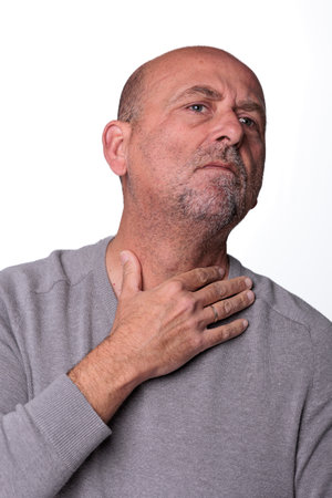 Close up headshot confident serious concentrated man over 50 looking at camera studio portrait, isolated on white studio backgroundの写真素材