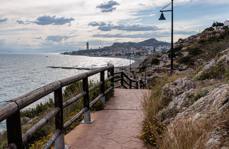 Picturesque walkway descending to the beach of la herradura, with views of cerro gordo natural parkの写真素材