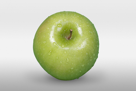Tasty green apple with drops on white background の写真素材