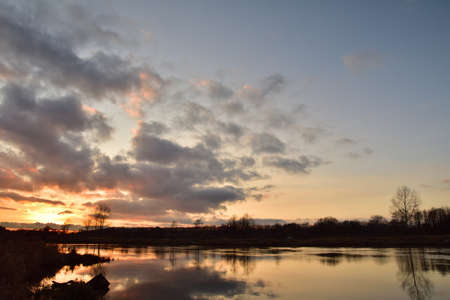Sunset over a wide river on a cool spring day. Fish eye lens. Spring.の写真素材