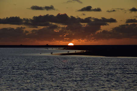 Fairy-tale sunset and clouds in the sky over the sea. Summer.