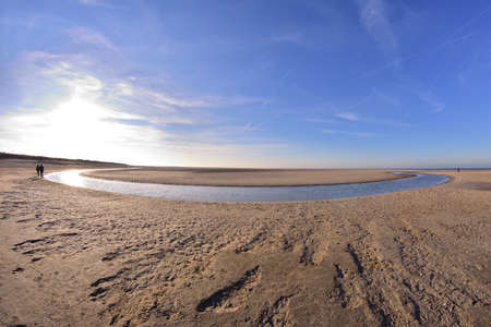 The beach and the sea coast on a sunny day in the fisheye lens. Spring.