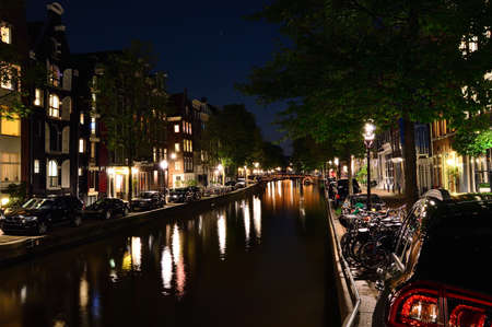 Bicycles and night on the canal in Amsterdam. Summer.の写真素材