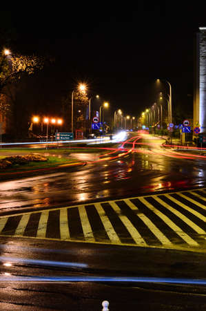 Car light streaks at night after rain. Night.