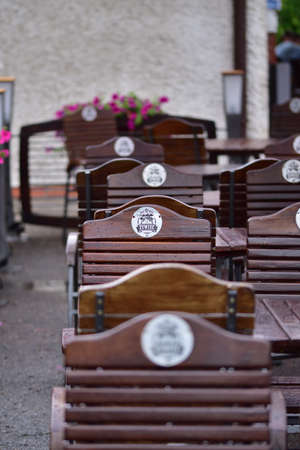 Zywiec branded chairs in a beer garden on a rainy day.のeditorial素材