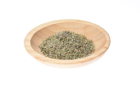 Coconut shavings in a wooden bowl against a white background.の写真素材