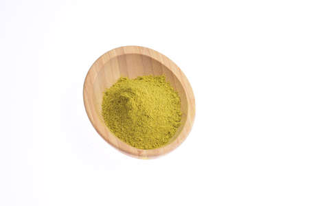 Herbal pepper on a wooden bowl against a white background. Food.の写真素材