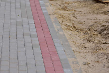 Bauma concrete paving stone pedestrian walkway under construction. White.の写真素材