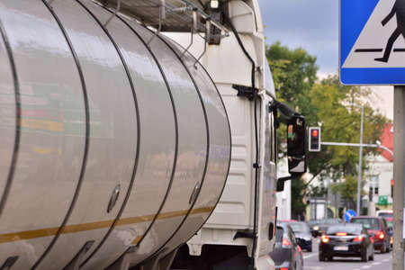 Tanker trucks are stuck in a traffic jam at a red light at an intersection. Intersection of light.の写真素材
