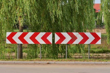Road barrier informing about the change of the direction of travel. Attention. Danger.の写真素材