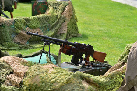 Vintage submachine guns and handguns on display in the historic summer on a sunny day. Summer. Day.