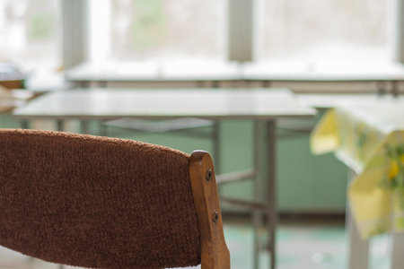 Chairs, a window and a table in an abandoned and dilapidated holiday house in the style of the People's Republic of Poland.の写真素材