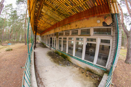 Dilapidated and abandoned building, roofing and terrace in a fisheye lens on an autumn day.の写真素材